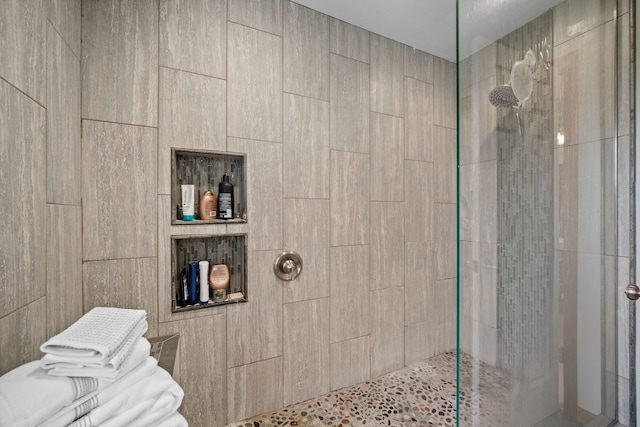 bathroom with a tile shower