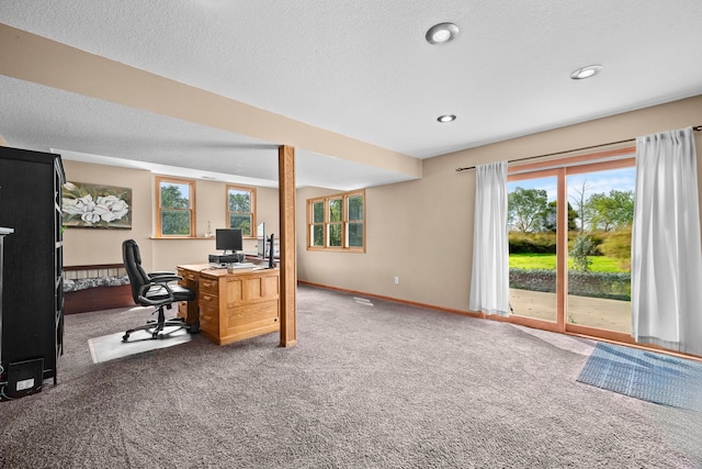 carpeted home office with a textured ceiling