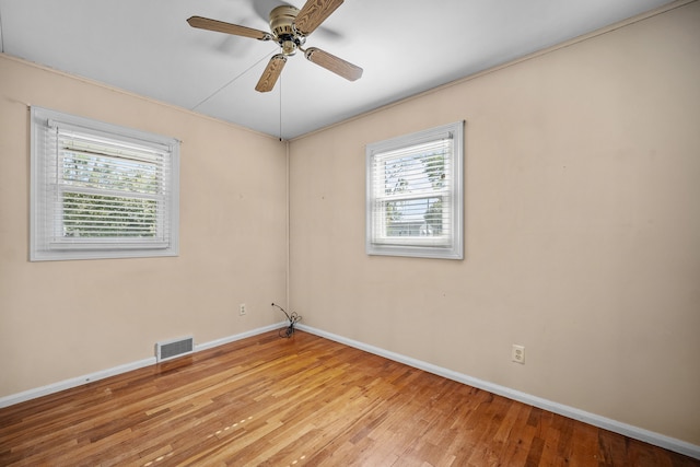 empty room with light hardwood / wood-style floors and ceiling fan