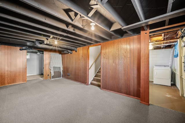 basement with washer / dryer and wooden walls