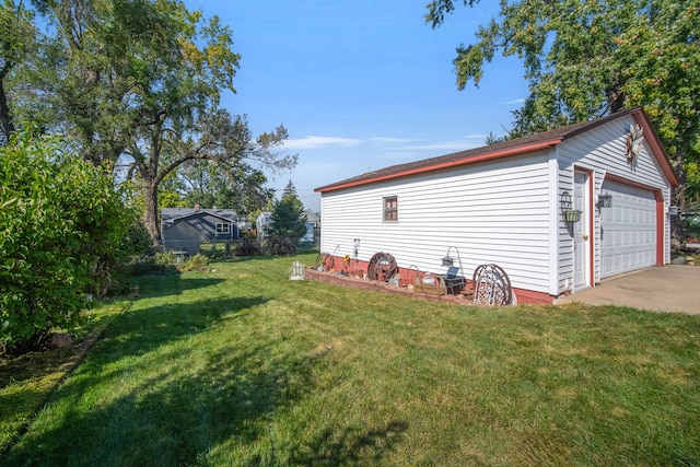 exterior space with a garage and an outbuilding