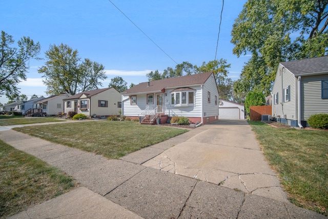 view of front of house featuring a front yard, an outdoor structure, cooling unit, and a garage