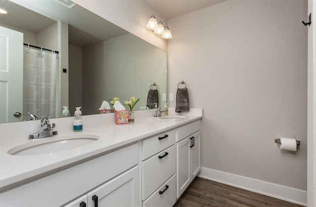 bathroom with vanity and wood-type flooring