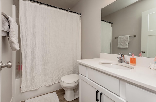 full bathroom with toilet, shower / bath combo, wood-type flooring, and vanity