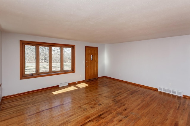 empty room featuring hardwood / wood-style floors