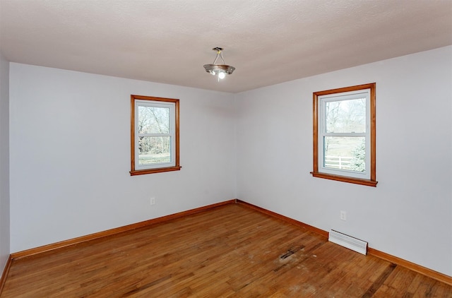 empty room with hardwood / wood-style floors