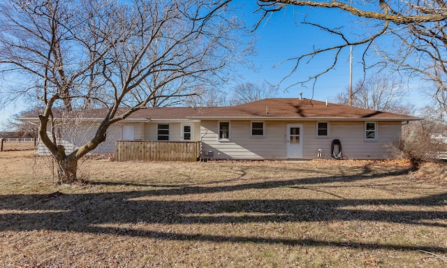 rear view of house featuring a yard