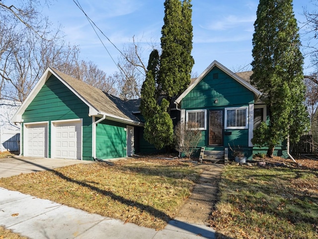 bungalow with a garage and a front yard