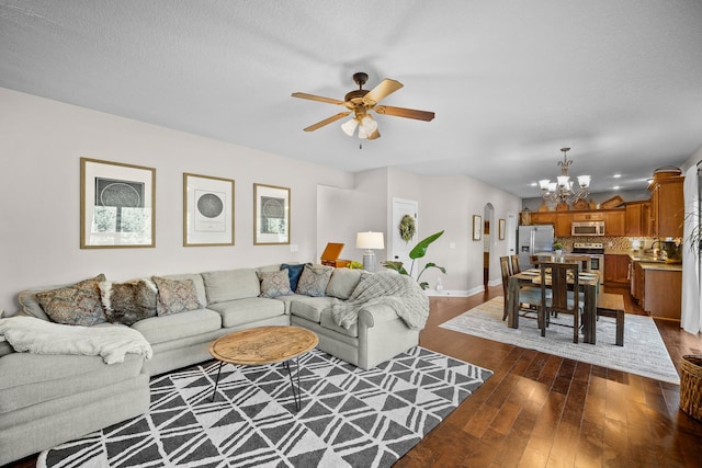 living room with sink, ceiling fan with notable chandelier, a textured ceiling, and dark hardwood / wood-style flooring