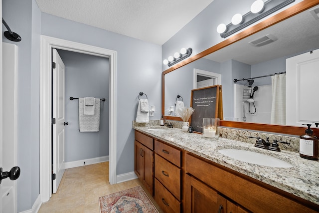 bathroom featuring vanity and a textured ceiling