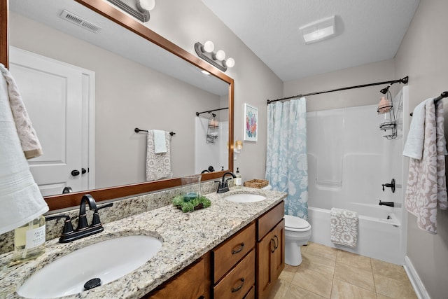 full bathroom featuring tile patterned floors, toilet, a textured ceiling, vanity, and shower / bath combo with shower curtain