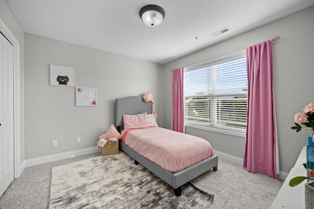 bedroom with light colored carpet