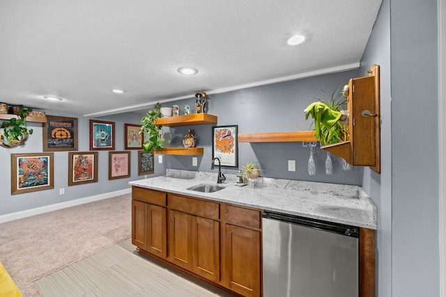 kitchen featuring sink, light colored carpet, stainless steel fridge, and light stone counters