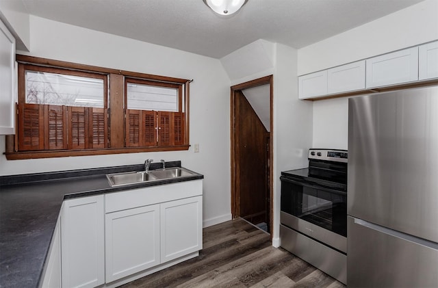 kitchen featuring sink, dark wood-type flooring, white cabinetry, and appliances with stainless steel finishes