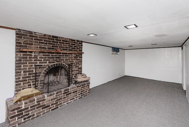 unfurnished living room featuring a fireplace, a textured ceiling, and dark colored carpet