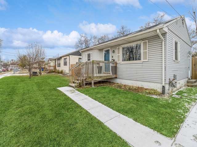 view of front of property with a front yard and a deck