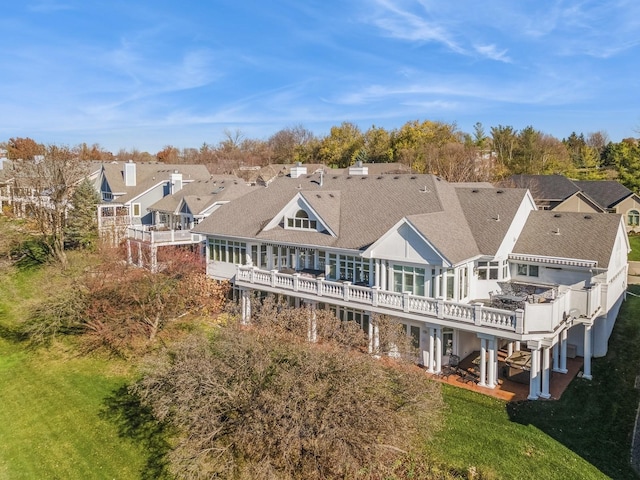 rear view of house with a wooden deck and a yard