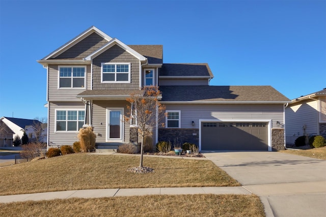 craftsman-style house featuring a garage and a front lawn