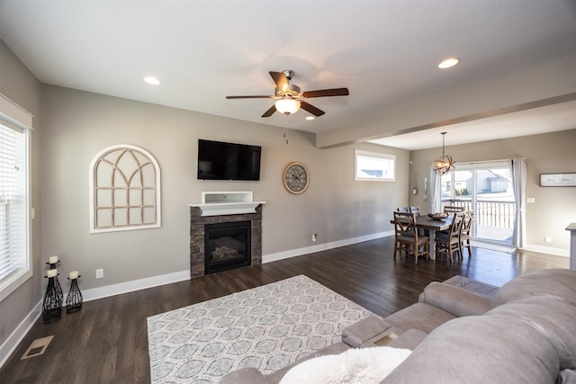 living room with ceiling fan and dark wood-type flooring