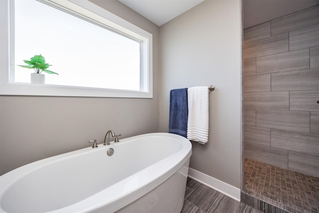 bathroom featuring independent shower and bath