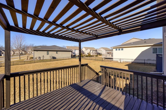 wooden deck featuring a yard and a pergola