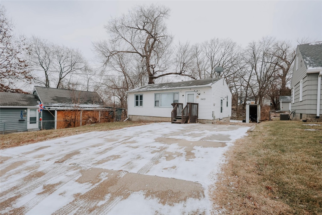 back of house with central AC unit