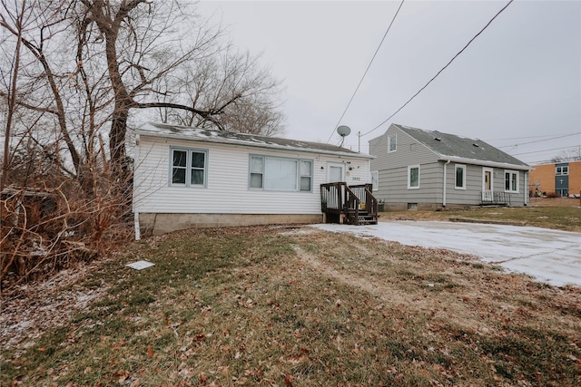 rear view of property featuring a yard