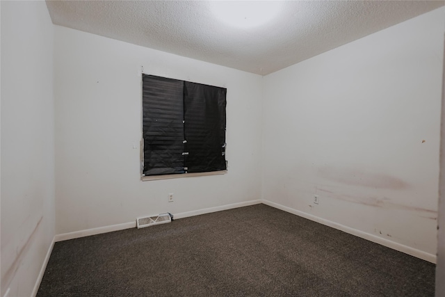 carpeted spare room featuring a textured ceiling