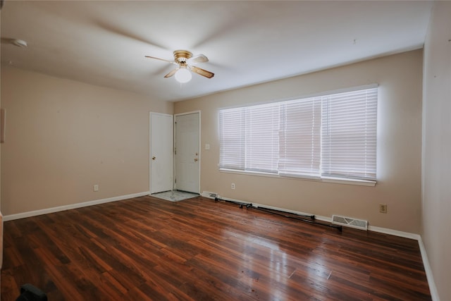 empty room featuring ceiling fan and dark hardwood / wood-style flooring