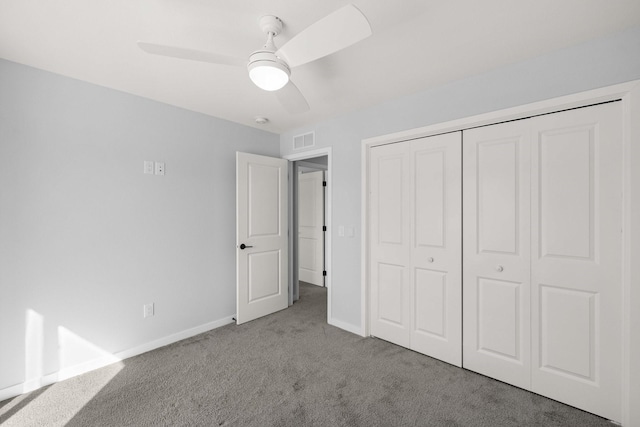 unfurnished bedroom with ceiling fan, light colored carpet, and a closet