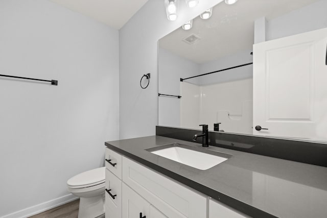 bathroom with vanity, toilet, a shower, and hardwood / wood-style floors