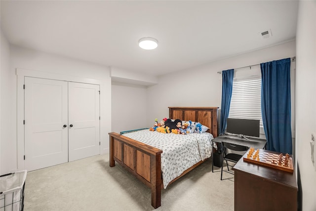 bedroom with a closet and light carpet