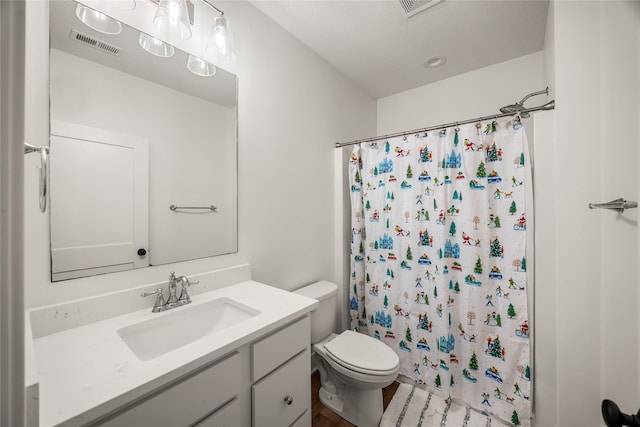 bathroom with a textured ceiling, toilet, a shower with shower curtain, and vanity