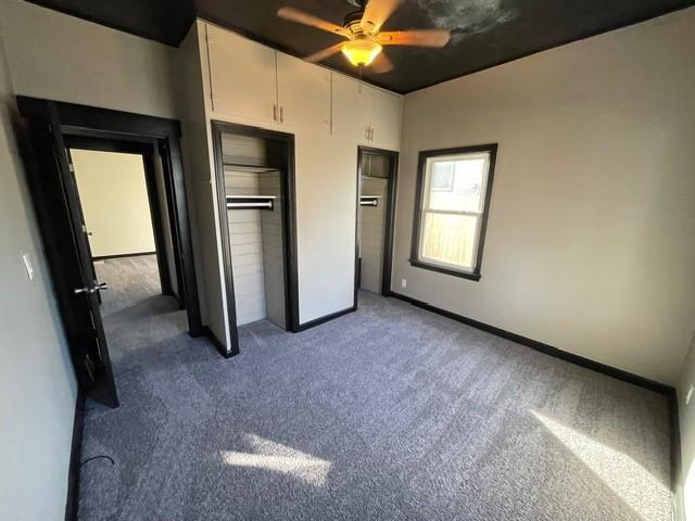 unfurnished bedroom featuring carpet and ceiling fan