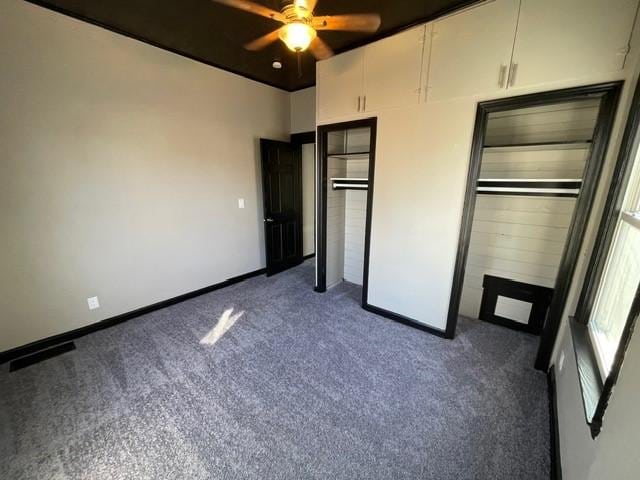 unfurnished bedroom featuring a closet, ceiling fan, and dark carpet