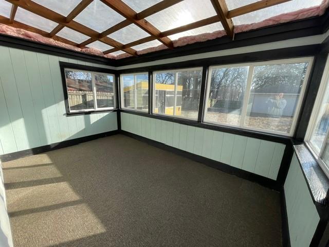 unfurnished sunroom with coffered ceiling and beamed ceiling