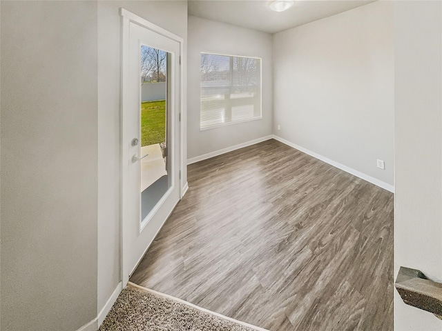 unfurnished room with wood-type flooring