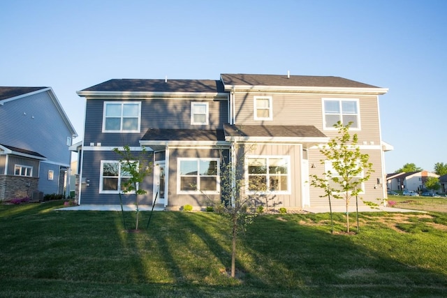 rear view of property with a lawn, central AC, and a patio