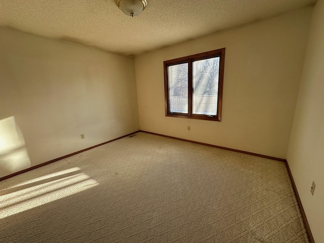 carpeted spare room featuring a textured ceiling