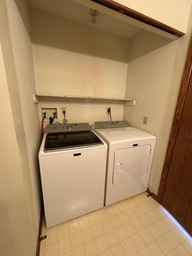 clothes washing area with washing machine and dryer