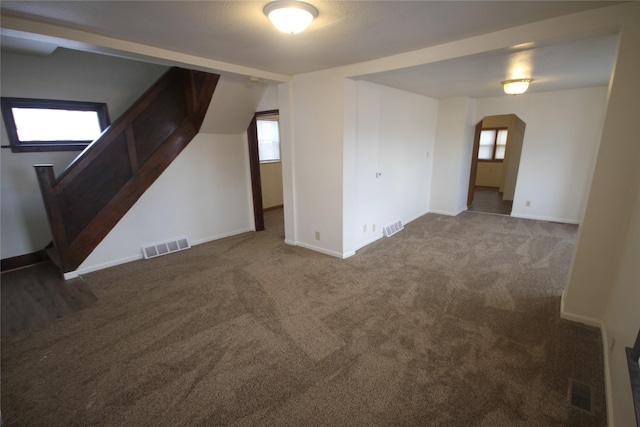 unfurnished room featuring dark carpet