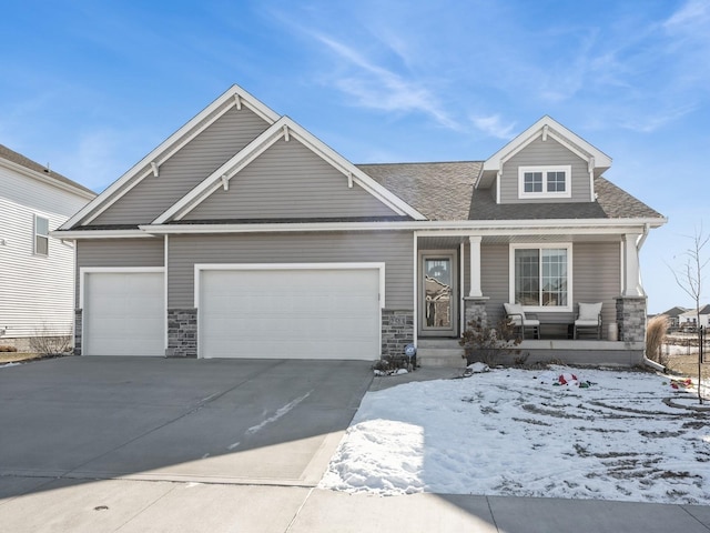 craftsman inspired home with a garage and covered porch