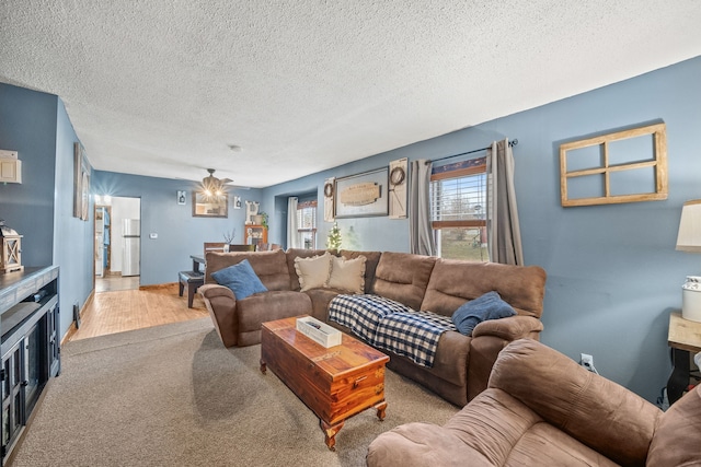 living room featuring a textured ceiling and light carpet