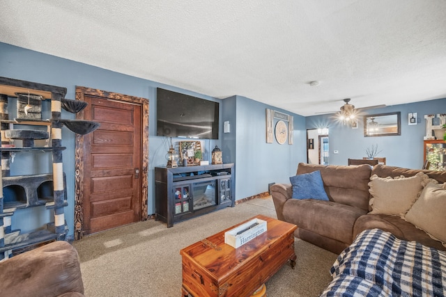 carpeted living room featuring a textured ceiling and ceiling fan