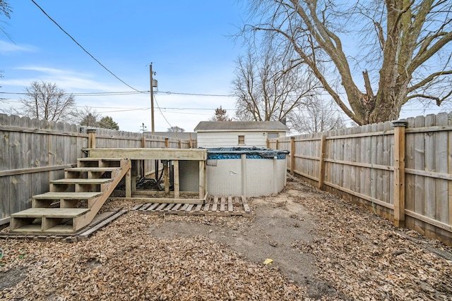 view of yard with a covered pool and an outdoor structure