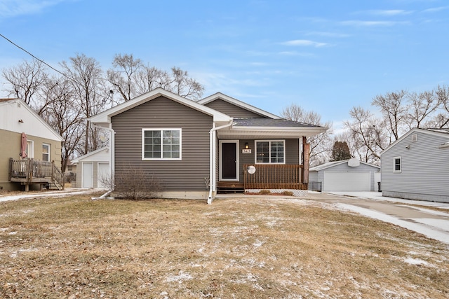 view of front of home featuring a front yard, an outbuilding, and a garage