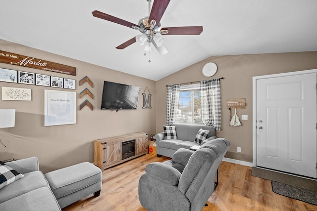 living room with light hardwood / wood-style floors, vaulted ceiling, and ceiling fan