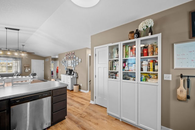 kitchen with lofted ceiling, light hardwood / wood-style floors, dishwasher, and hanging light fixtures