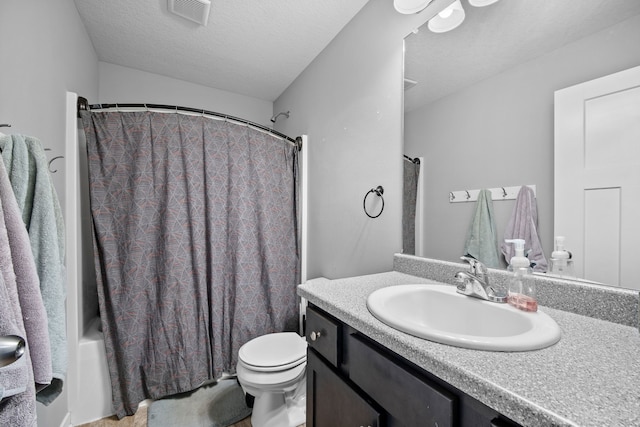 full bathroom featuring shower / bath combo with shower curtain, a textured ceiling, toilet, and vanity