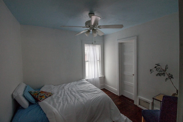 bedroom featuring ceiling fan and dark wood-type flooring